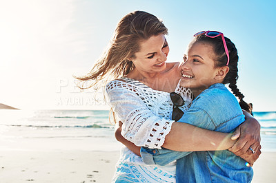 Buy stock photo Cropped shot of an attractive mature woman spending the day at the beach with her daughter