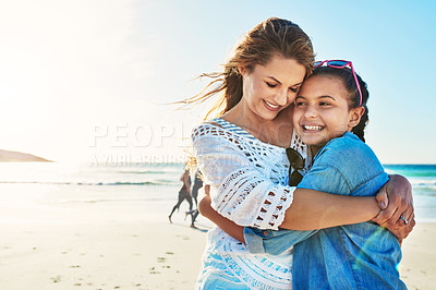 Buy stock photo Cropped shot of an attractive mature woman spending the day at the beach with her daughter