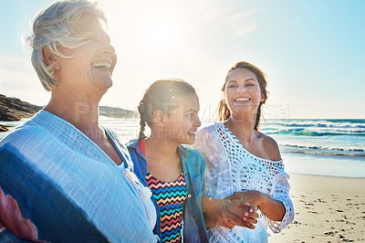 Buy stock photo Cropped shot of a senior woman spending the day at the beach with her daughter and granddaughter