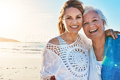 Buy stock photo Cropped portrait of a senior woman and her adult daughter spending a day at the beach
