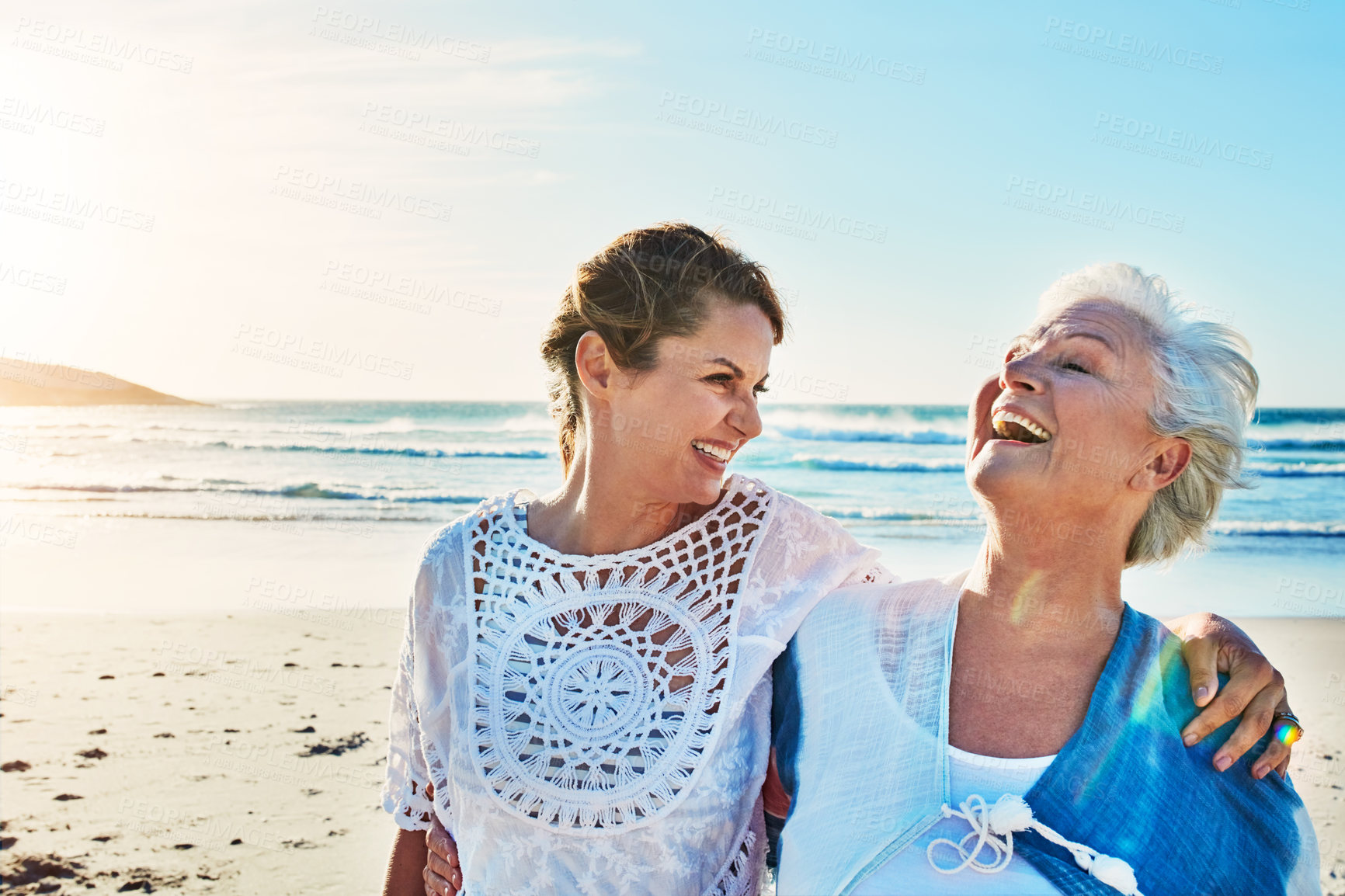 Buy stock photo Cropped shot of a senior woman and her adult daughter spending a day at the beach