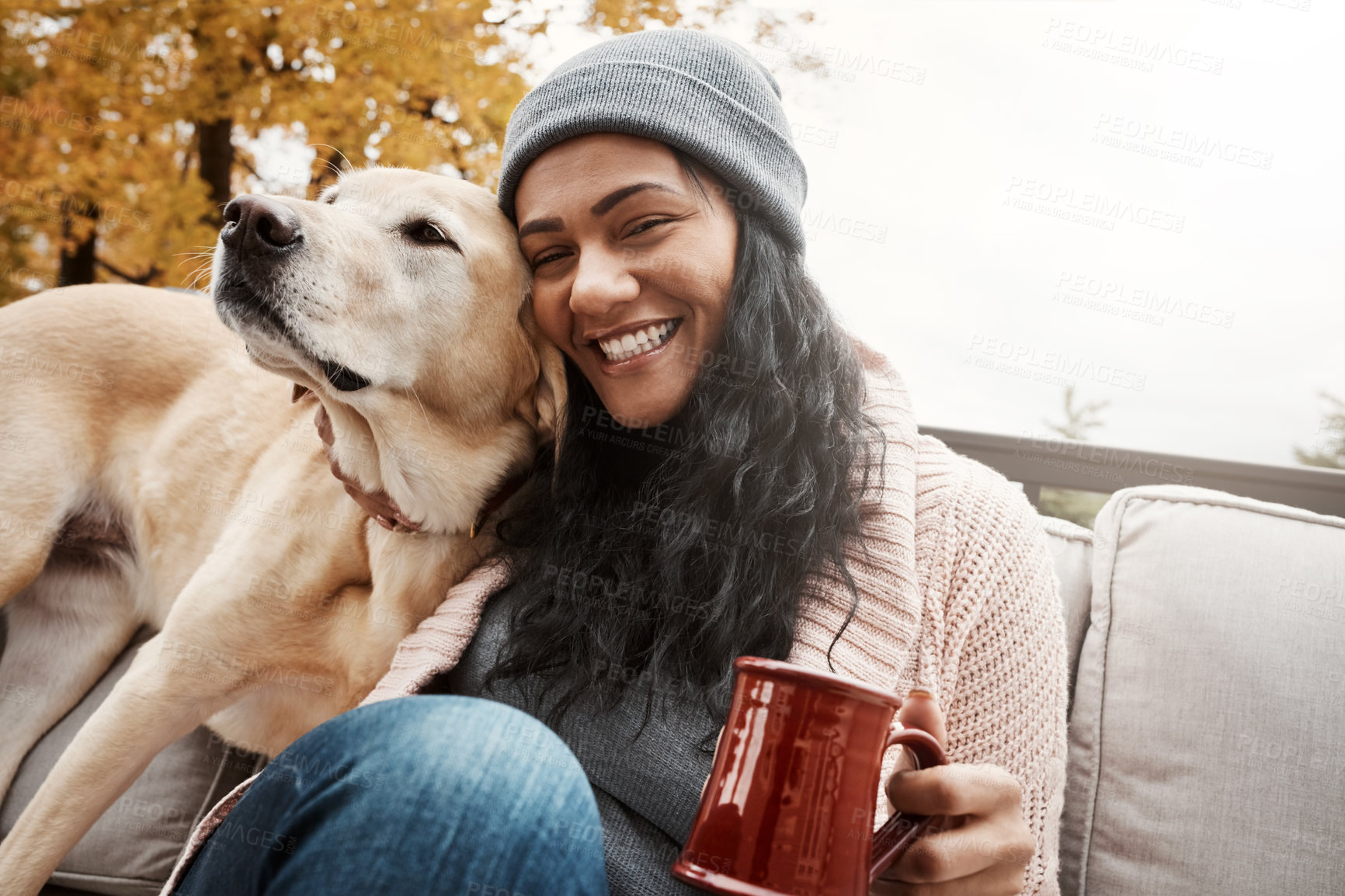 Buy stock photo Shot of a young woman relaxing with her dog outside