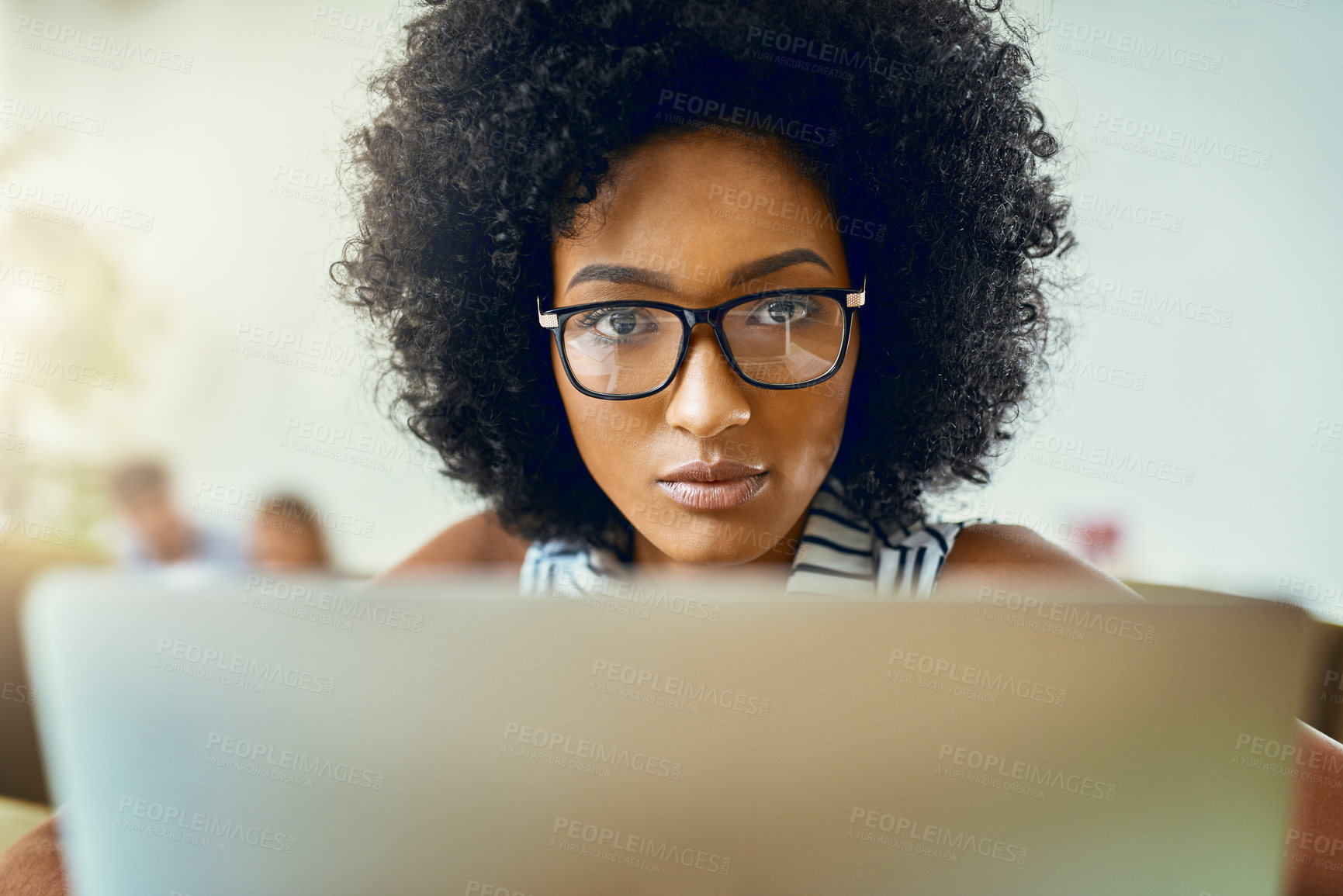 Buy stock photo Woman, African and working with laptop, office and company as web designer in digital agency. Female person, pride and concentration on technology for assignment, project or brief in creative career