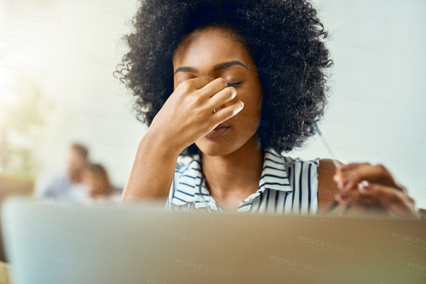 Buy stock photo Cropped shot of a young female designer experiencing a headache in a modern office