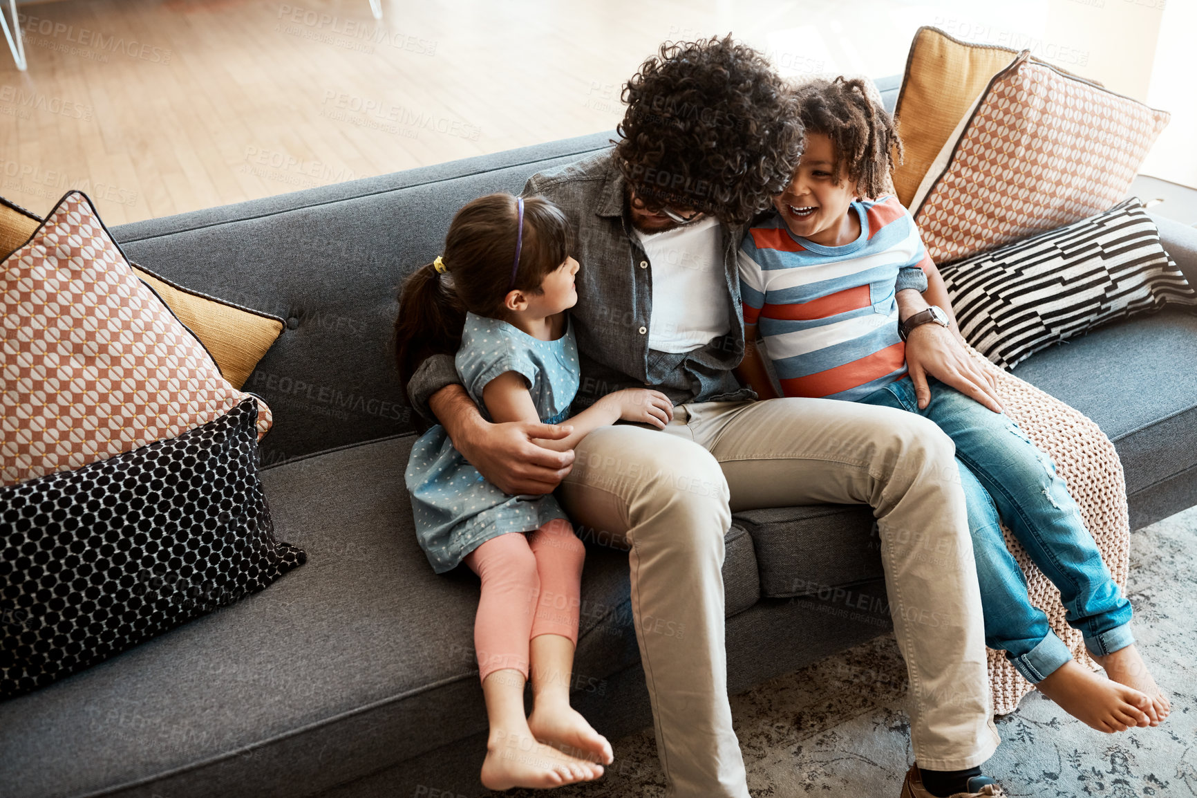 Buy stock photo Family, dad and children with hug on sofa for love, gratitude and connection together in living room. Care, happy and man with embrace of kids at home for trust, bonding and parenting on weekend