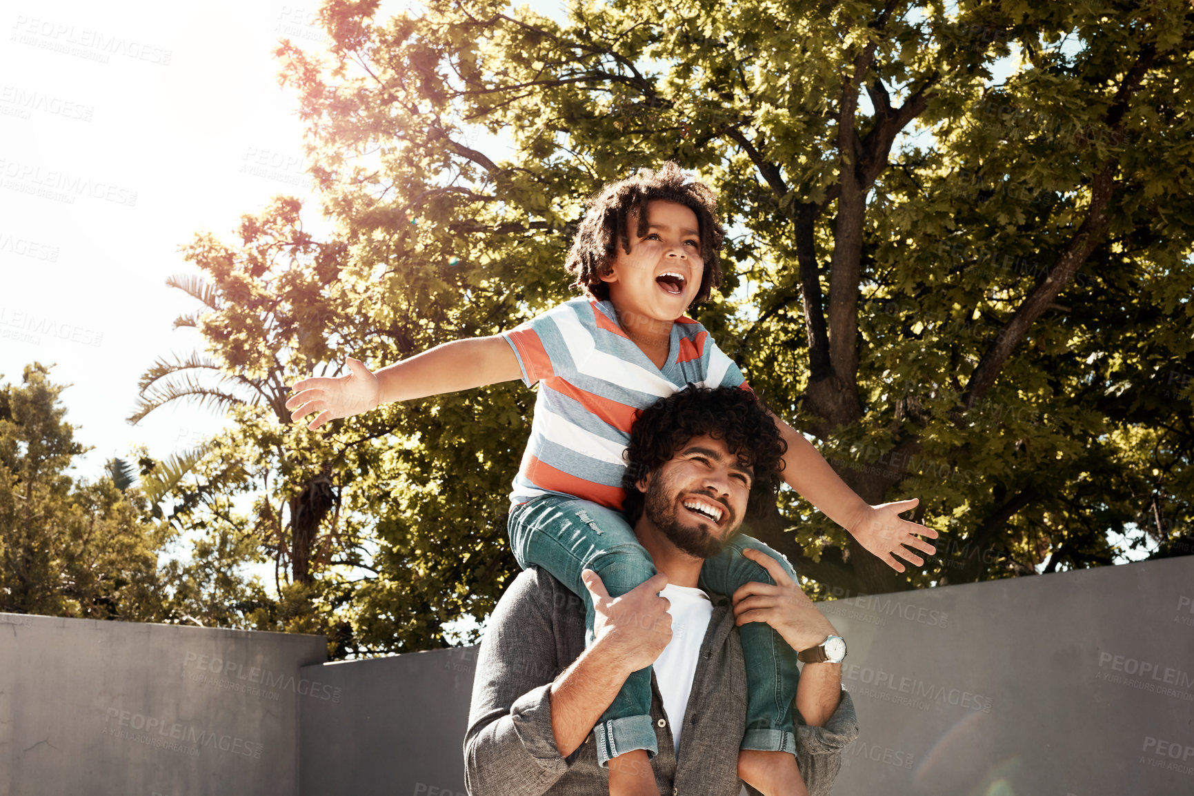 Buy stock photo Happy father, child and bonding or carry on shoulders at backyard for love, freedom or holiday together at home. Dad with son, kid or little boy for fun flying game or enjoying weekend in nature