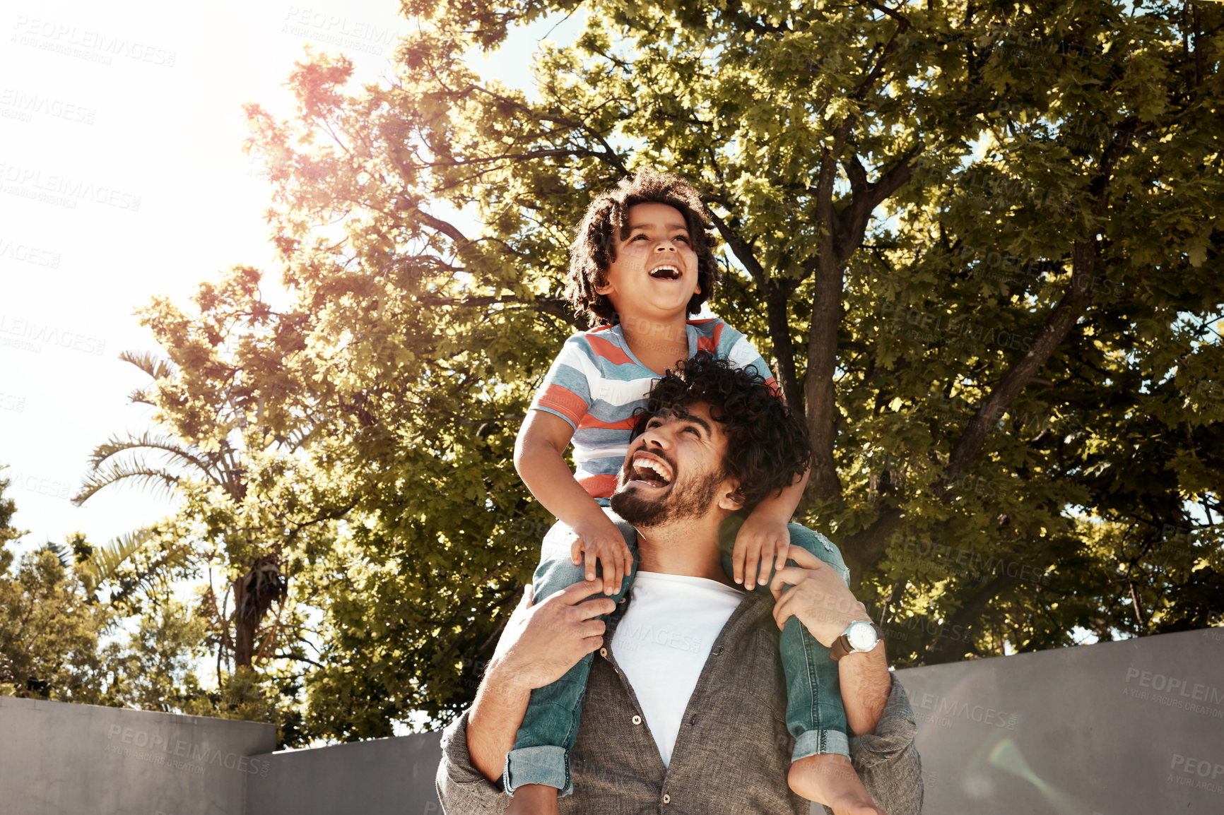 Buy stock photo Happy father, boy and love with piggyback at backyard on holiday, freedom or bonding together at home. Dad with young child, son or little kid with smile on shoulder for weekend in outdoor nature