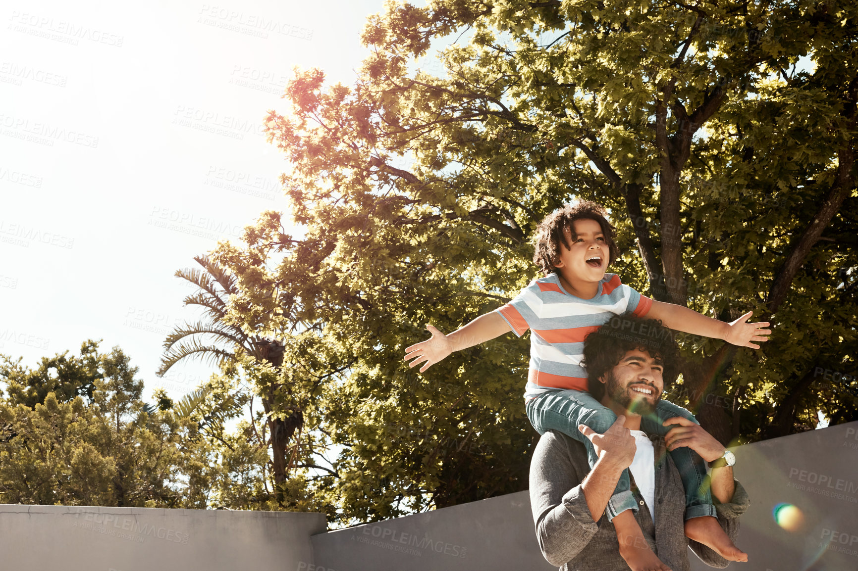 Buy stock photo Happy dad, son and bonding with piggyback at backyard for love, freedom or holiday together at home. Father with child, kid or little boy on shoulder for fun flying or enjoying weekend in nature