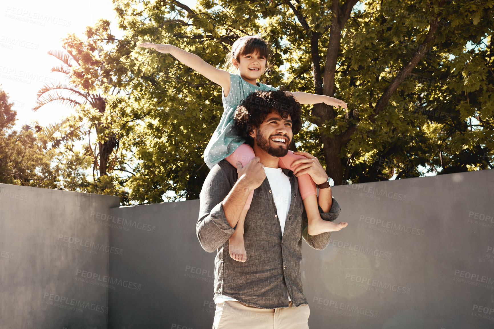 Buy stock photo Happy father, daughter and bonding with piggyback at backyard for love, freedom or holiday together at home. Dad with child, kid or little girl for shoulder, fun flying or enjoying weekend in nature