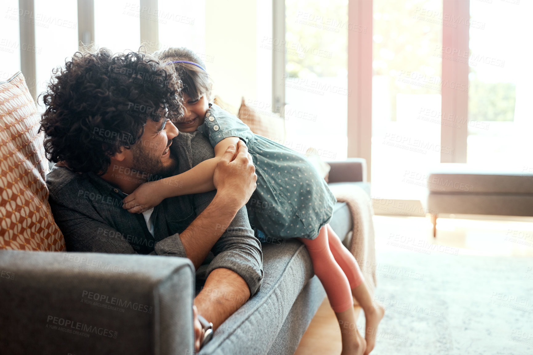 Buy stock photo Family, man and daughter with hug on sofa for care, gratitude and bonding together in living room. Smile, love and dad with embrace of girl at home for childhood, appreciation and support on weekend