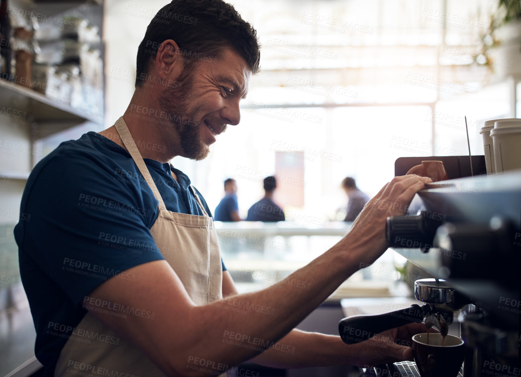 Buy stock photo Shot of a barista operating a coffee machine in a cafe