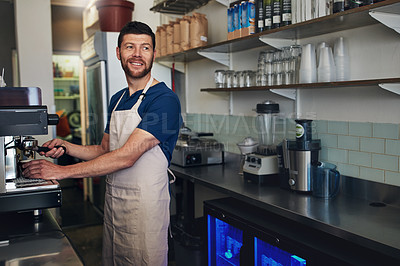 Buy stock photo Shot of a barista operating a coffee machine in a cafe