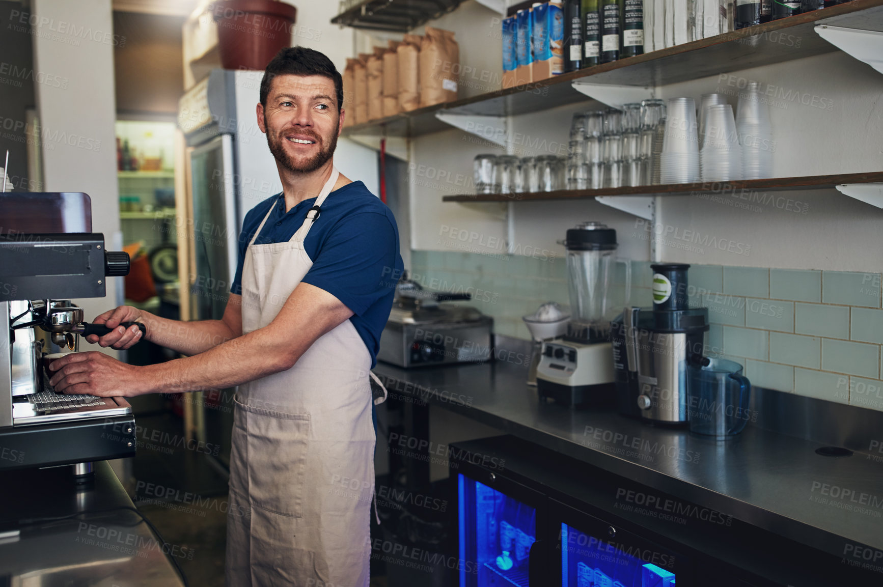 Buy stock photo Shot of a barista operating a coffee machine in a cafe