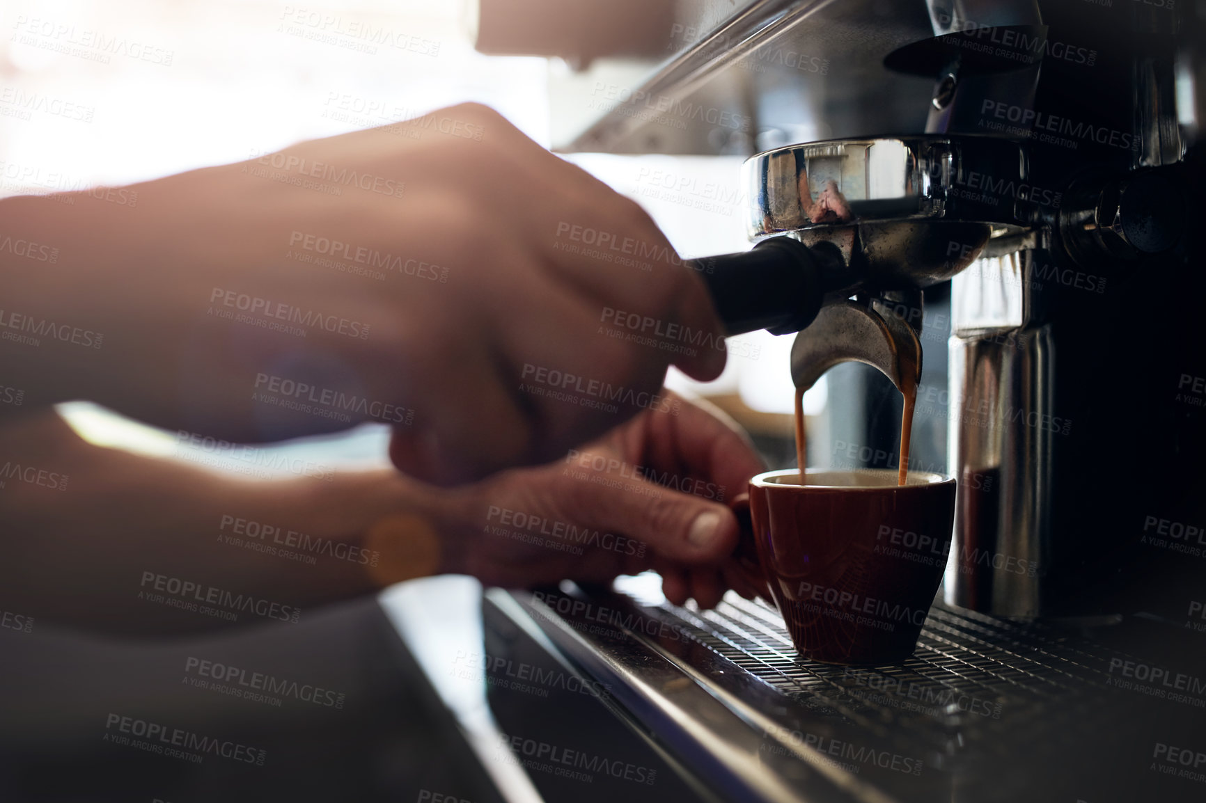 Buy stock photo Closeup shot of an unrecognizable barista operating a coffee machine in a cafe