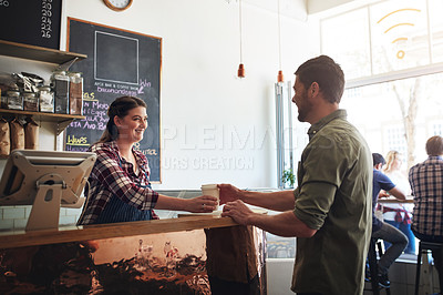 Buy stock photo Shot of a waitress serving coffee to a customer in a cafe