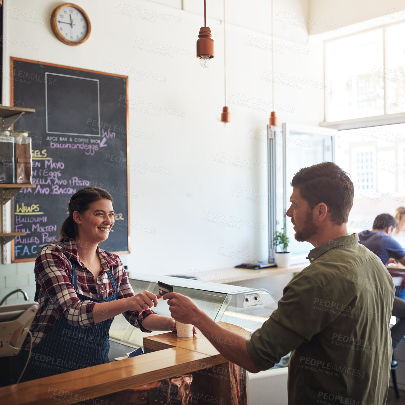 Buy stock photo Shot of a customer making a credit card payment in a cafe