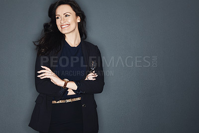 Buy stock photo Studio shot of a young attractive corporate businesswoman posing against a grey background