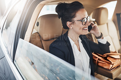 Buy stock photo Shot of a confident young business woman seated in a car as a passenger and talking on her cellphone while  going to work