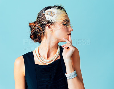 Buy stock photo Vintage, studio and thinking woman with fashion, attitude and outfit for new year retro party or gala. Blue background, confidence and girl with net veil, feather headpiece for classic rich style