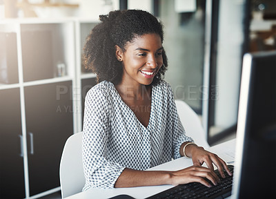 Buy stock photo Shot of a young businesswoman working on a computer in an office