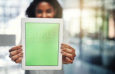 Buy stock photo Shot of a young businesswoman holding up a digital tablet with a chroma key screen in an office