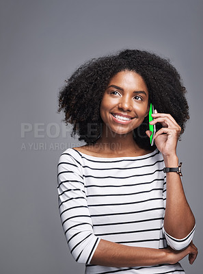 Buy stock photo Studio shot of a young woman using a mobile phone against a gray background
