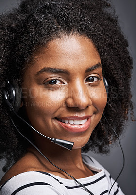 Buy stock photo Studio portrait of a confident young phone operator posing against a gray background