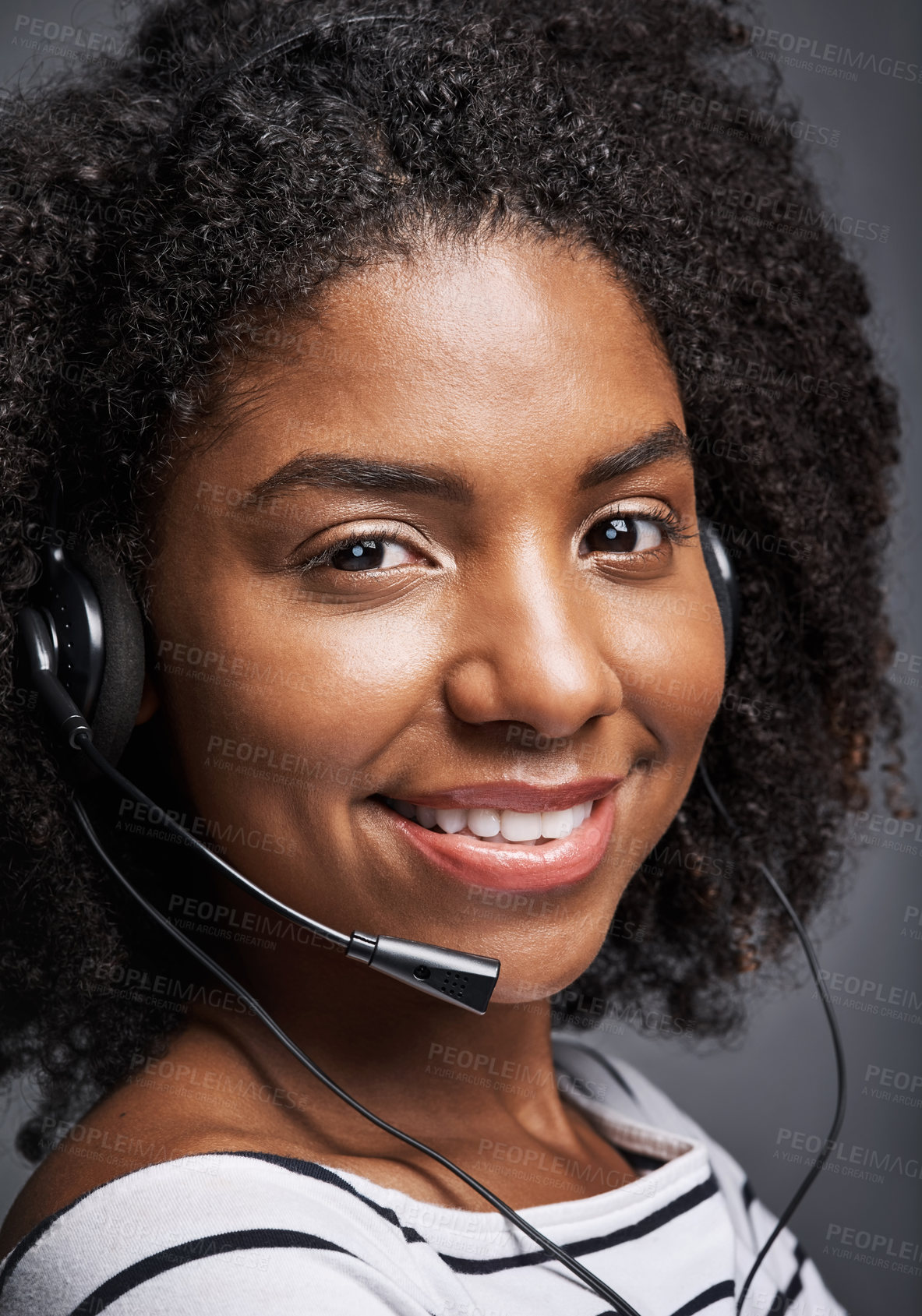 Buy stock photo Studio portrait of a confident young phone operator posing against a gray background