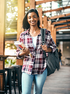 Buy stock photo Cropped shot of a young female student holding textbooks on her way to class on campus