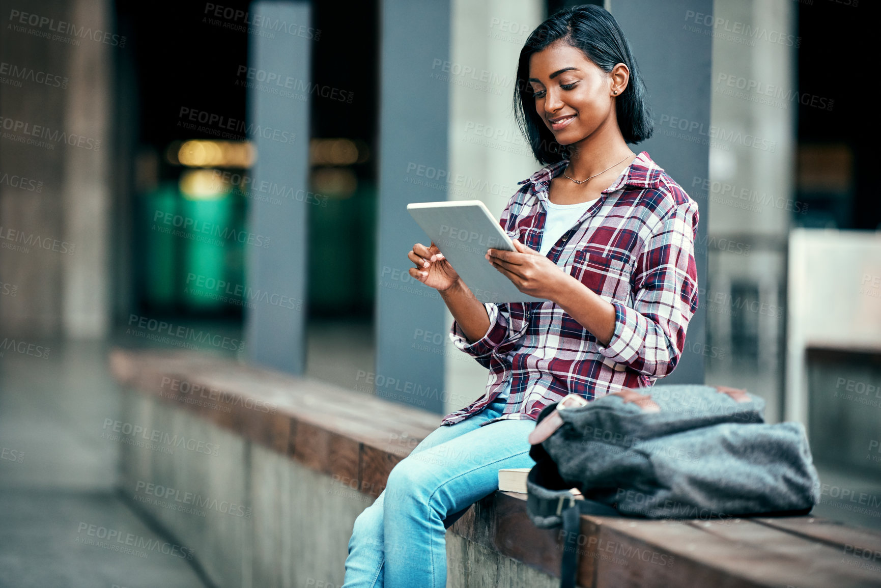 Buy stock photo Girl, college student and tablet at campus with bag, education or reading to prepare for class. Indian person, notification and e learning app for study, assessment or happy for results at university