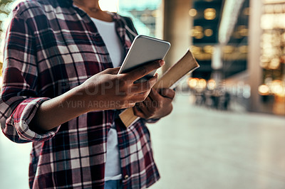 Buy stock photo Cropped shot of an unrecognizable female student using a cellphone outside on campus
