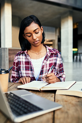 Buy stock photo Cropped shot of a young female student studying outside on campus