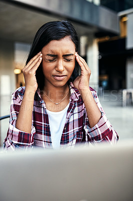Buy stock photo Cropped shot of a young female student experiencing a headache outside on campus