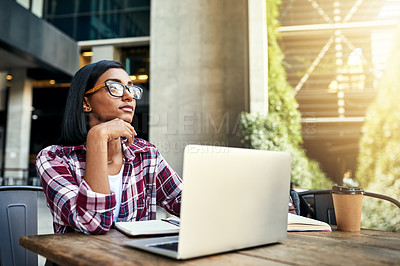 Buy stock photo Cropped shot of a young female student using a laptop outside on campus
