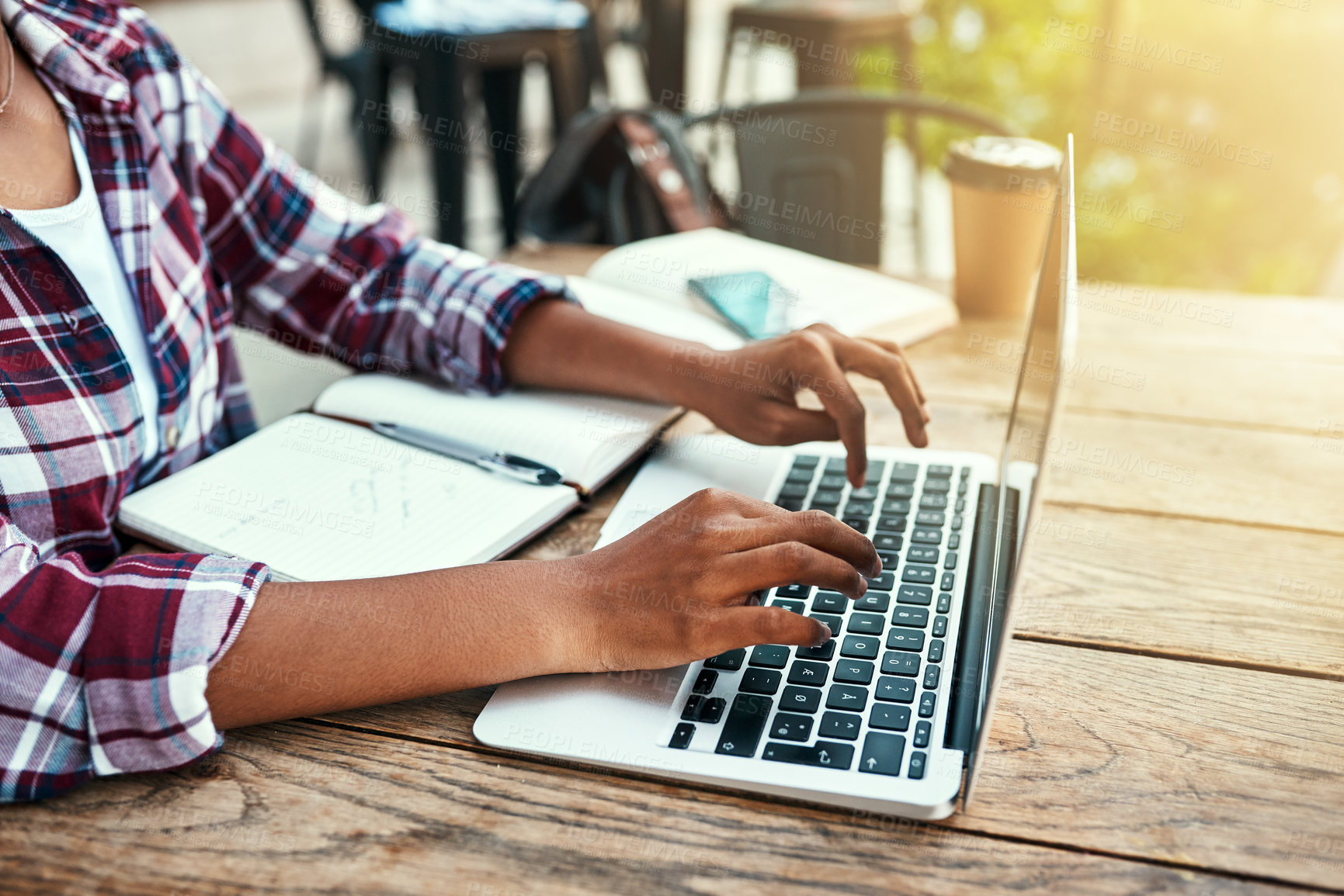 Buy stock photo Student, hands and typing in cafe, laptop and studying with notebook, table and practice for college. University, digital and person in coffee shop, learning and planning for exam, knowledge and tech