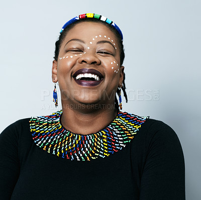 Buy stock photo Studio portrait of a cheerful middle aged woman smiling brightly while standing against a grey background