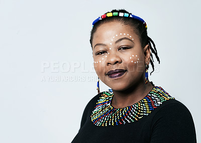 Buy stock photo Studio portrait of a confident middle aged woman looking at the camera while standing against a grey background