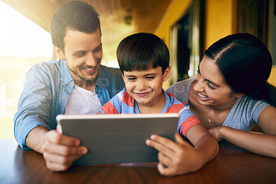 Buy stock photo Cropped shot of an affectionate young family using a tablet together at home