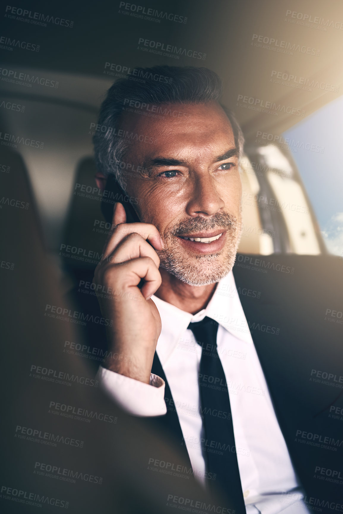 Buy stock photo Shot of a mature businessman using a mobile phone while traveling in a helicopter