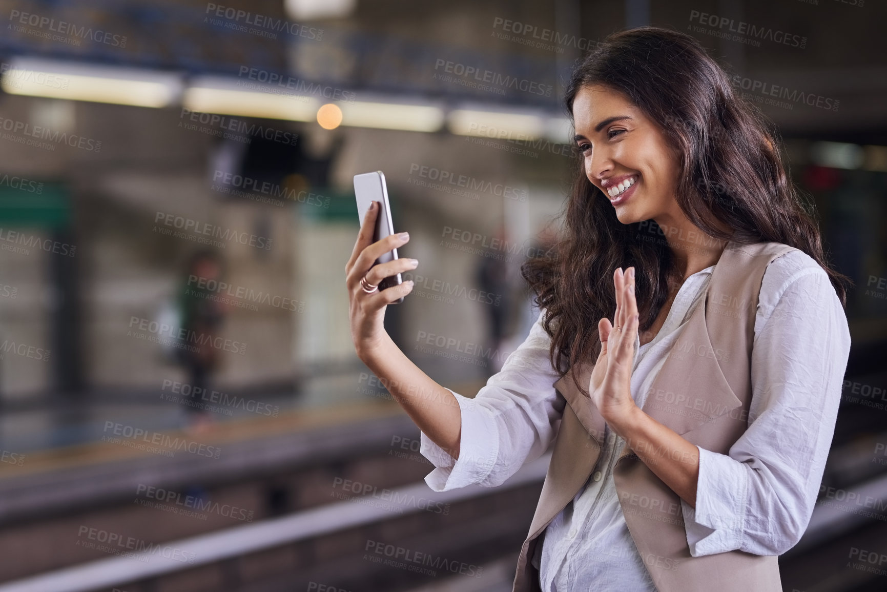 Buy stock photo Cropped shot of a young attractive woman video calling with her cellphone while commuting with the train