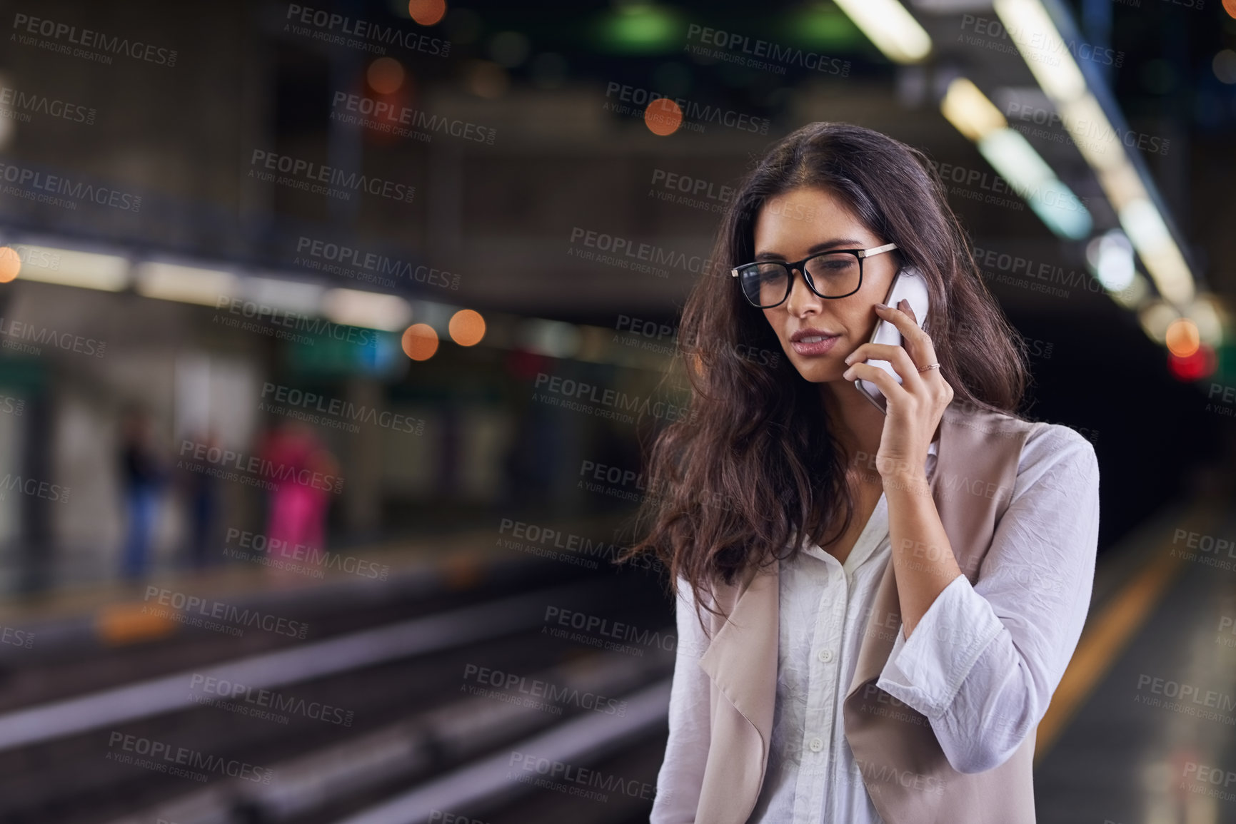 Buy stock photo Cropped shot of a young attractive woman on a call and using the train to commute