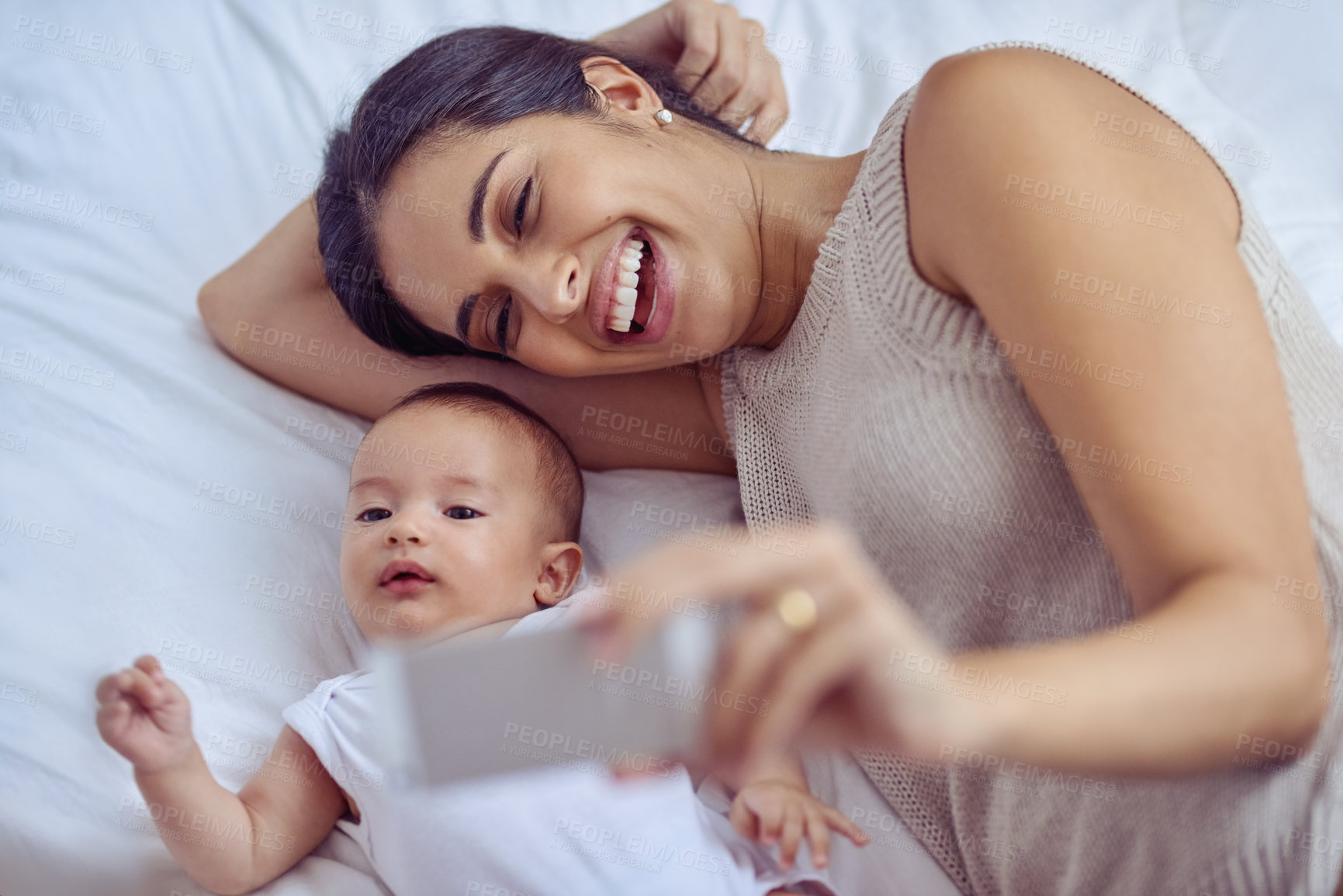 Buy stock photo Shot of a young woman taking selfies with her adorable baby boy at home