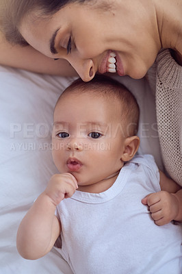 Buy stock photo High angle shot of a young woman bonding with her baby boy at home