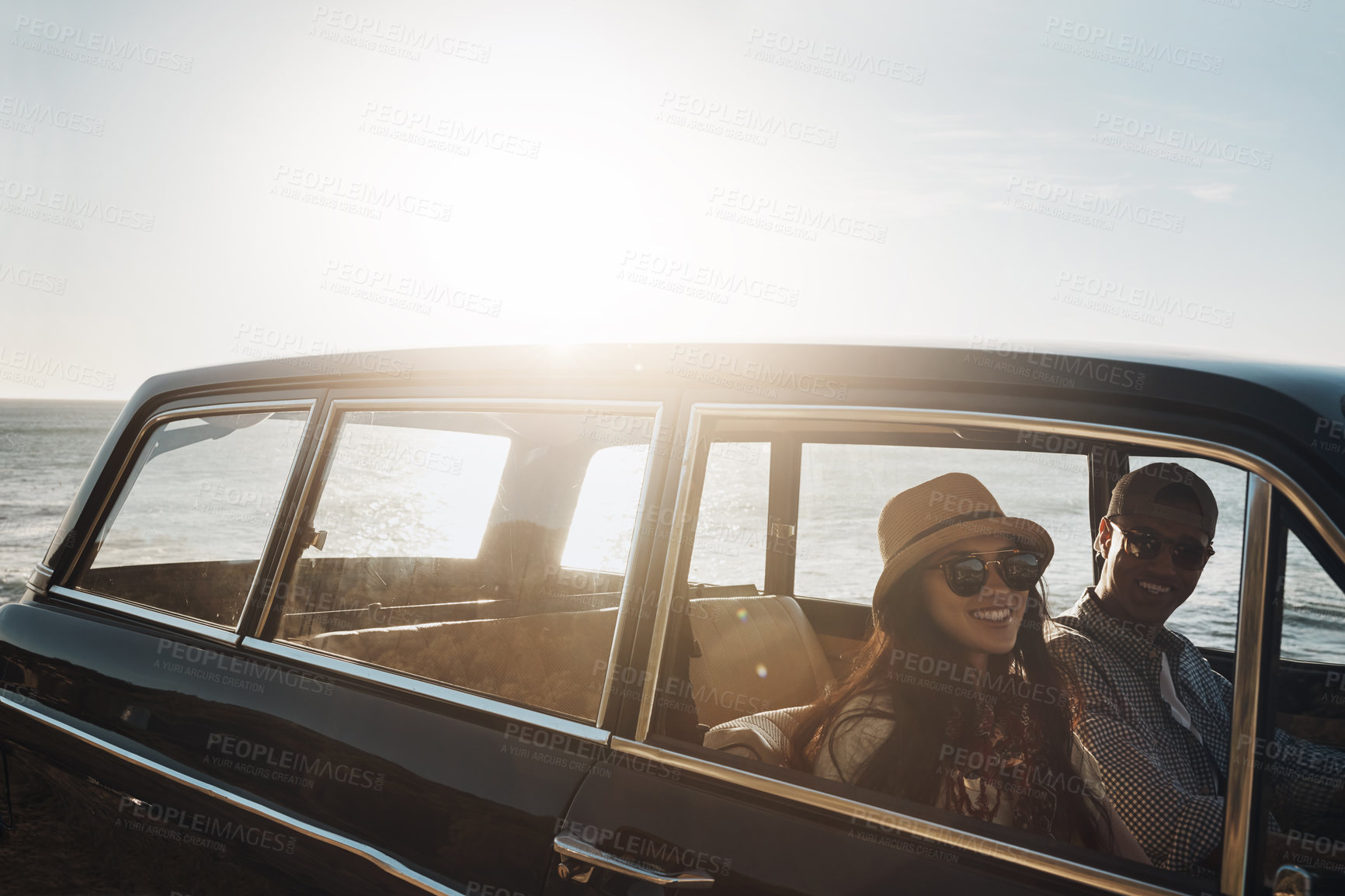 Buy stock photo Portrait of a young couple enjoying a road trip along the coast