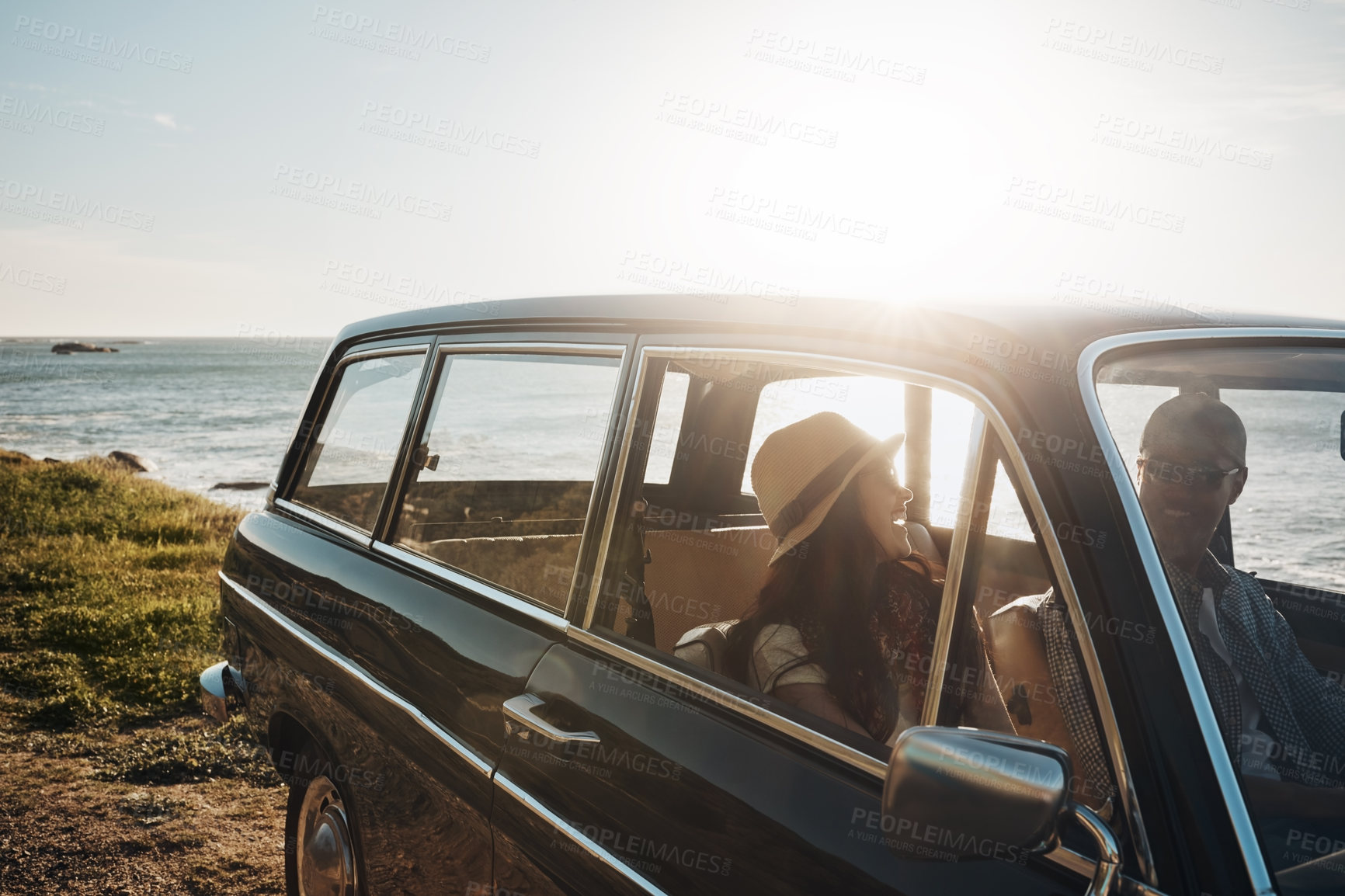 Buy stock photo Couple, happy and travel in car by ocean, talk and mockup space in sunshine, holiday or memory. Man, woman and road trip for connection, love and transport with bonding in summer at beach in Naples