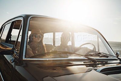 Buy stock photo Couple, beach and together in car for road trip with view, relax or sunglasses on vacation. Man, woman and interracial love for travel, transportation and journey by sea for happy memory in Australia