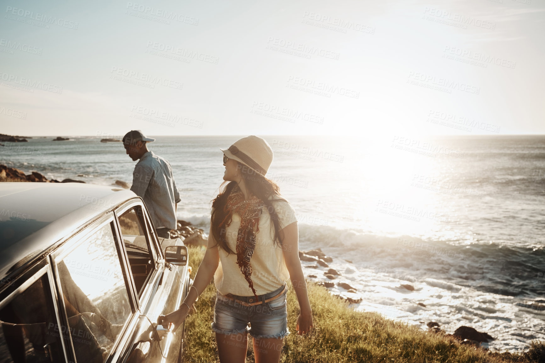 Buy stock photo Shot of a young couple enjoying a road trip along the coast