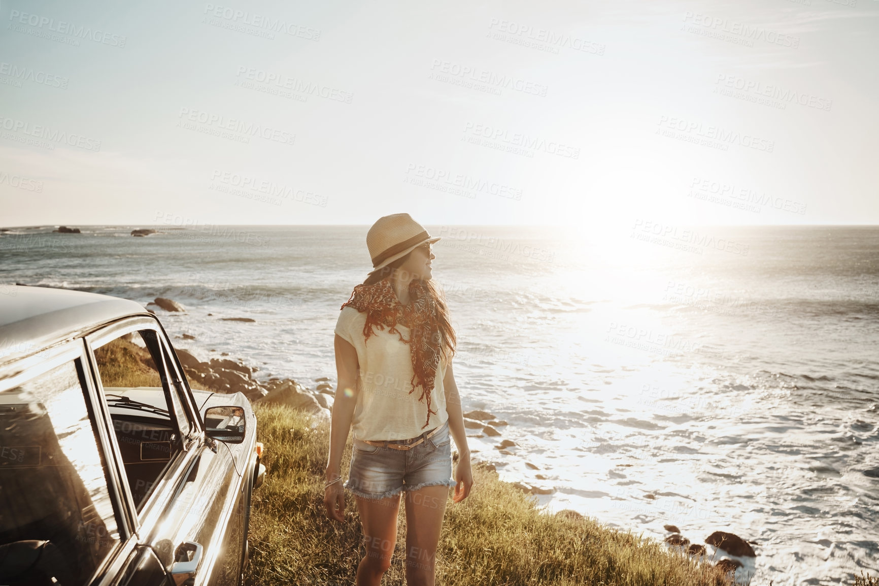 Buy stock photo Road trip, travel and woman in car by ocean on holiday, vacation and summer weekend in countryside. Happy, nature view and person by vehicle by seaside for relaxing, journey and adventure in morning