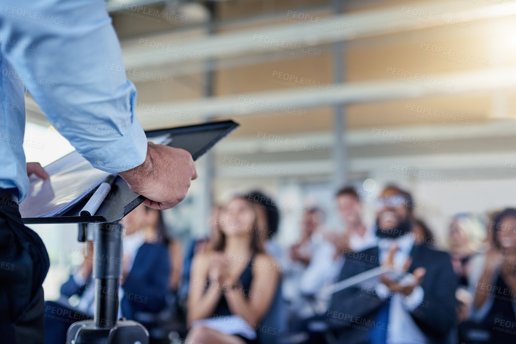 Buy stock photo Closeup, presentation and speaker with crowd, applause or speech with workshop, seminar or discussion. Zoom, male person or leader with audience, announcement or motivation with support or solidarity