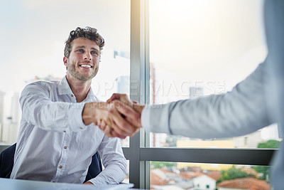 Buy stock photo Shot of two businessmen shaking hands in an office